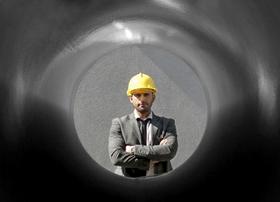 Man Looking through Pipe